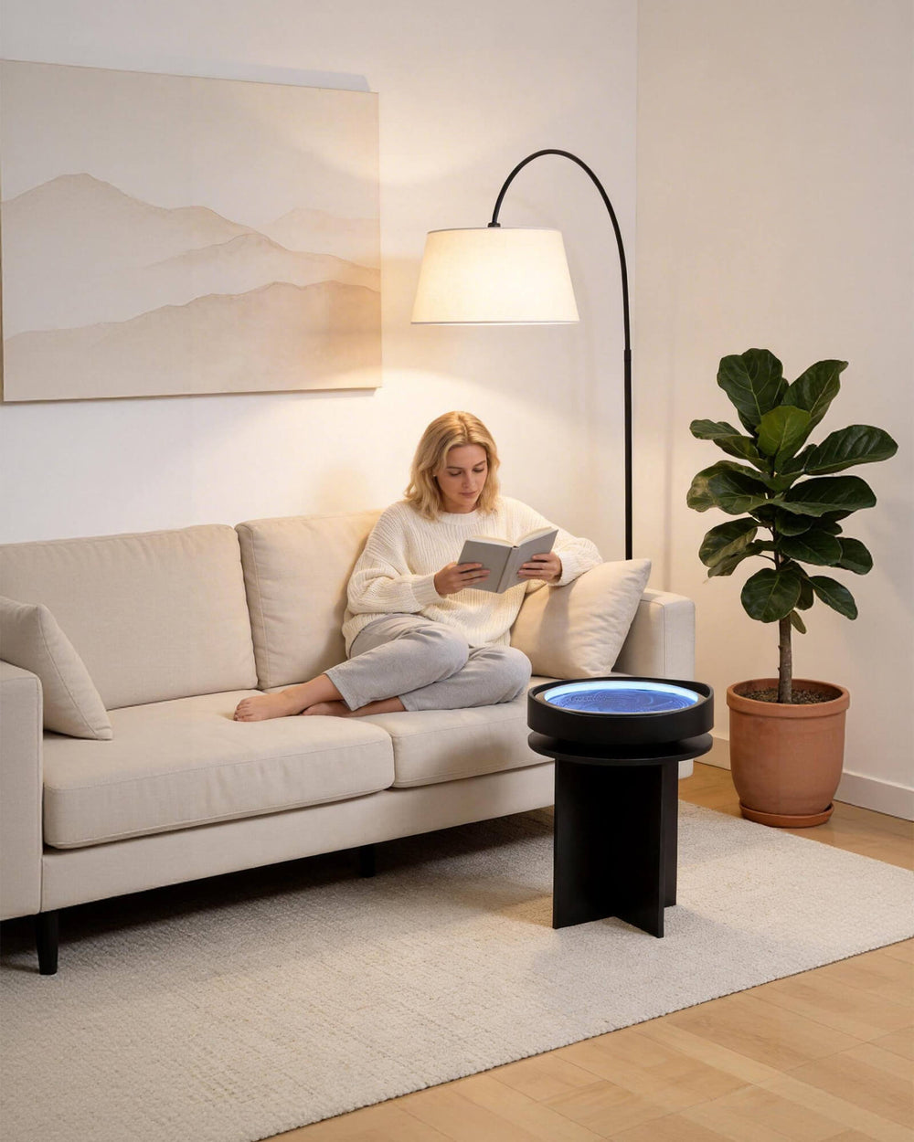 Woman reading beside Lemofuta Roji side table in a living room